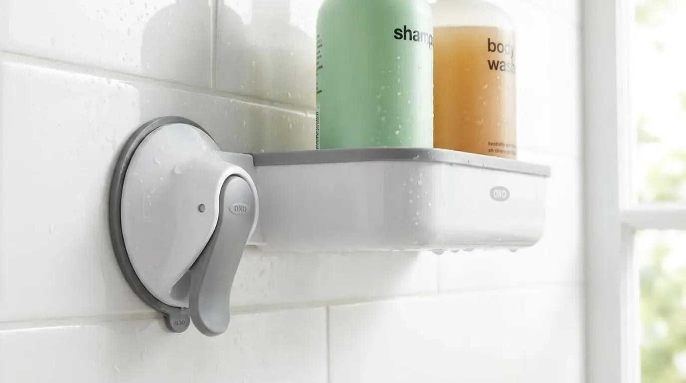 Suction cup shower shelf holding shampoo and body wash on tile wall